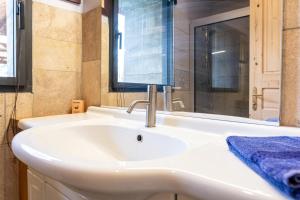 a bathroom with a white sink and a mirror at Appartement Des Fontaines Albiez in Albiez-le-Jeune +20 photos