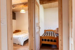 a small bedroom with a bed and a room with a window at Appartement Des Fontaines Albiez in Albiez-le-Jeune