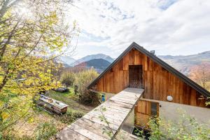 a wooden barn with a ramp leading up to it at Appartement Des Fontaines Albiez in Albiez-le-Jeune