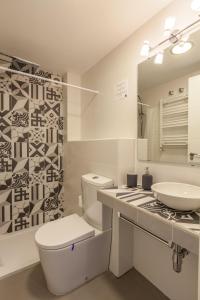a white bathroom with a sink and a toilet at Orbyz in Seville +24 photos