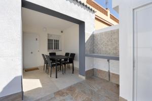 a dining room with a black table and black chairs at Casa Camposoto in San Fernando