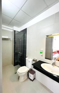 a bathroom with a toilet and a sink and a shower at Dalat ECO Hotel 2 in Da Lat