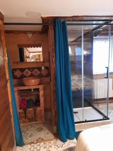 a bedroom with blue curtains in a room at Le Mont De La Source in Lafarre