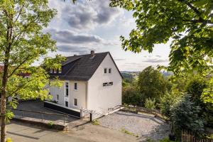 a white house with a black roof at Haus Fürstenberg Komplett in Fürstenberg