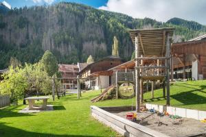 a playground in a village with a mountain in the background at Kaltenhauser Hof in Masserie