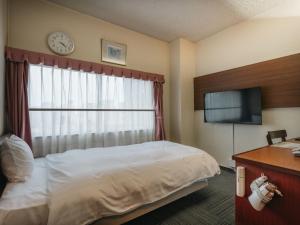 a hotel room with a bed and a television at Hotel Union in Kagoshima +145 photos