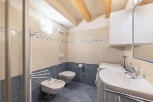 a bathroom with a toilet and a sink at Apartment Latemar Casa Alma in Tesero +9 photos