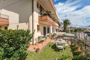 a balcony of a building with a table and chairs at Villa Veronica in Mascali