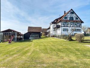 a large house with a grassy yard in front of it at Haus Hilebrand in Kressbronn am Bodensee