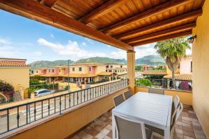 a balcony with a table and chairs and a view at Villa Tramonto in Villasimius