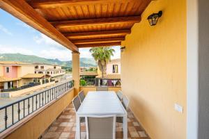 a white table on a balcony with a view at Villa Tramonto in Villasimius