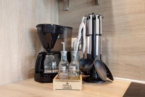 a kitchen counter with a coffee maker and utensils at Kornblume in Unterwittighausen