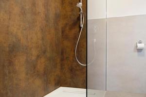 a shower with a glass door in a bathroom at Kornblume in Unterwittighausen +19 photos