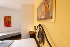 a room with a bed and a painting on the wall at Casa Samira a Otranto in Otranto