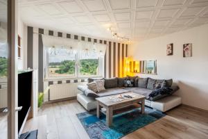 a living room with a couch and a table at Familie Heiko Schroth in Neußen
