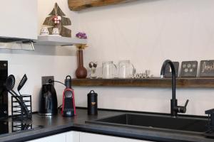 a kitchen with a sink and a counter top at Chez Margot Et Sophie in Torgnon +22 photos