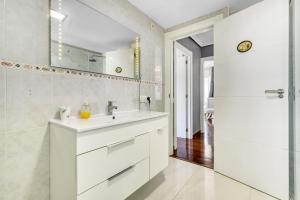 a white bathroom with a sink and a mirror at Altea Beach in Altea +17 photos