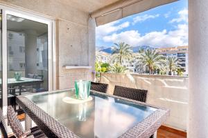 a glass table and chairs on a balcony with a view at Altea Beach in Altea