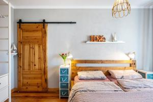 a bedroom with two beds and a wooden door at Koogbutze in Wesselburenerkoog