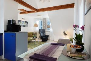 a living room with a table and a blue refrigerator at Ferienwohnungen Steiert in Freiburg im Breisgau