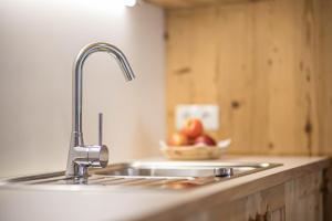 a sink in a kitchen with a bowl of fruit at Ciasa Silvia in San Martino in Badia