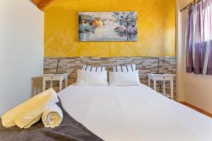 a bedroom with a large white bed with two tables at Chabela's Penthouse in Lajita