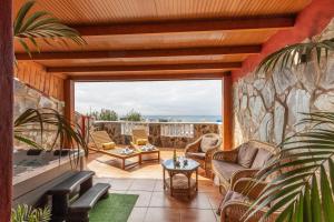 a living room with a stone wall at Chabela's Penthouse in Lajita