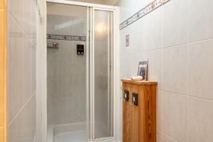 a shower with a glass door in a bathroom at Zunerhof Studio Fenn in Longostagno +22 photos