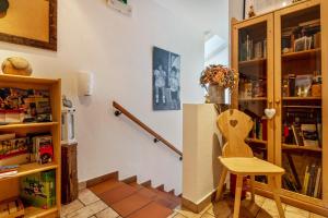 a room with a staircase and a table and a chair at Zunerhof Studio Fenn in Longostagno