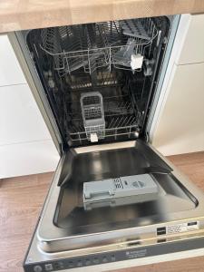 a dishwasher with its door open with a device inside at Domaine 3016 in Roquebrune-sur-Argens