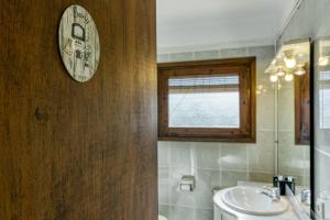 a bathroom with a sink and a clock on the wall at Can Picola in Capmany +27 photos
