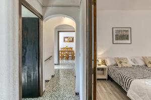 a bedroom with a bed and a dining room at Can Picola in Capmany