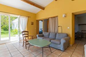 a living room with a couch and a table at La Bellimure in Saint-Christol