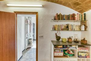 a room with a book shelf filled with books at Can Picola in Capmany