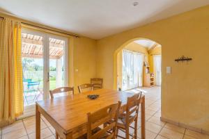 a dining room with a wooden table and chairs at La Bellimure in Saint-Christol +17 photos