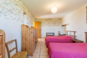 a room with two beds and a table and chairs at La Bellimure in Saint-Christol