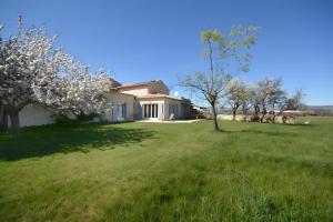 a house in a field with trees in the yard at La Bellimure in Saint-Christol