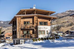 a wooden house in the snow in front at Ciasa Rungg App Corones in San Vigilio Di Marebbe