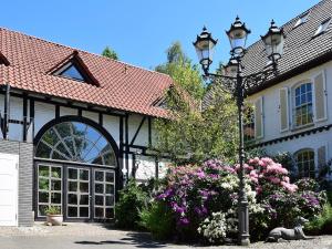 a street light in front of a house with flowers at Landhaus Bornemann in Diemelsee