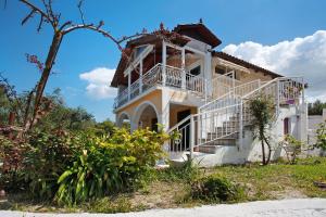 a large white house with a balcony at Zante View Family Studio 1 in Tsilivi
