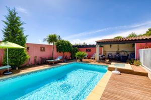 a swimming pool with a deck and a house at Location Fontaine de Sarac in Clermont-lʼHérault