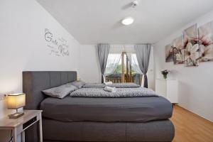 a bedroom with a large bed and a window at Martin´s Alm in Friesenried