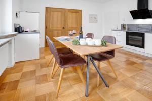 a kitchen with a wooden table and chairs in a kitchen at Goldberg in Grünstadt +12 photos