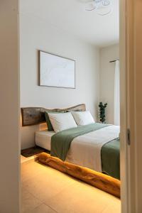 a bedroom with a large bed with a wooden frame at Sofia's central suite in Alexandroupoli