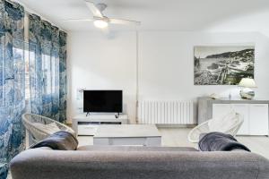 a living room with a couch and a tv at Casa en Begur reformada in Begur
