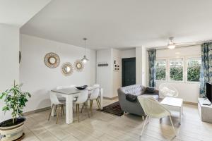 a dining room and living room with a table and chairs at Casa en Begur reformada in Begur