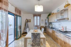 a kitchen with a table and a counter top at Il Girasole in Torre Vado