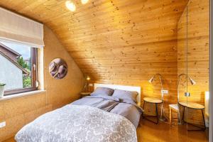 a bedroom with a bed and a wooden wall at Ferienwohnung Kalkau in Lichtenstein