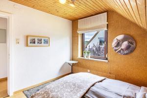 a bedroom with a bed and a window at Ferienwohnung Kalkau in Lichtenstein +19 photos