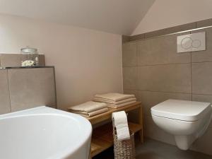 a bathroom with a white toilet and a sink at Meerzeit in Eckernförde +24 photos